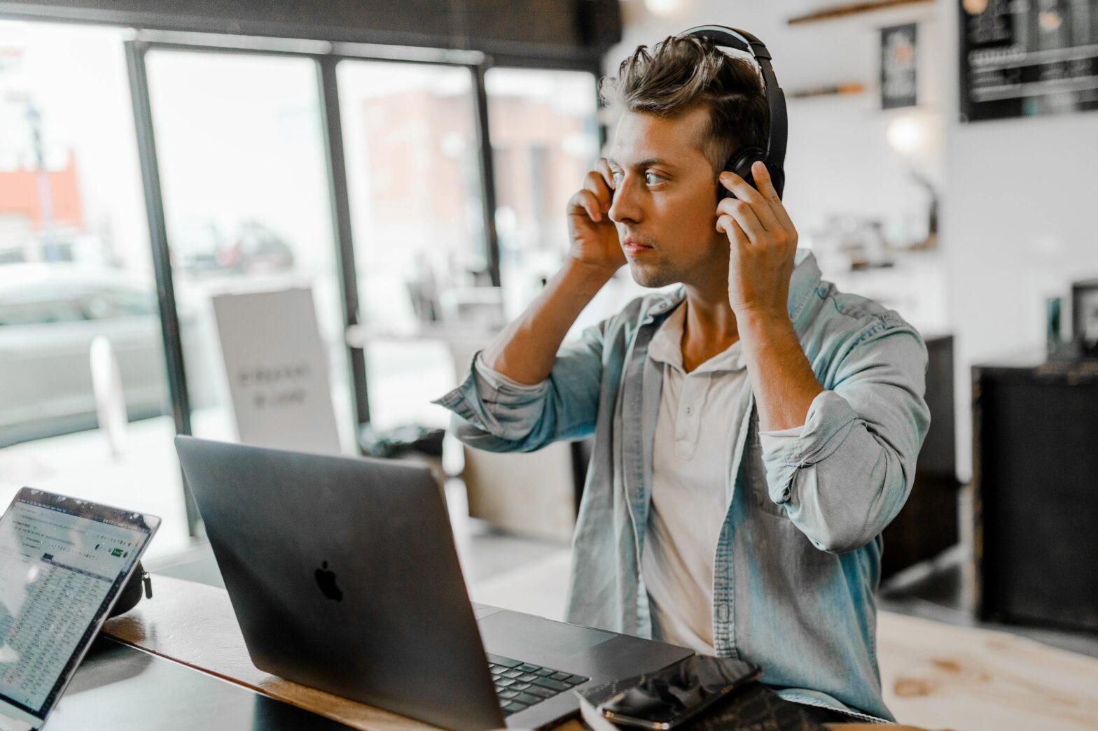 Man trying on headphones before a business meeting