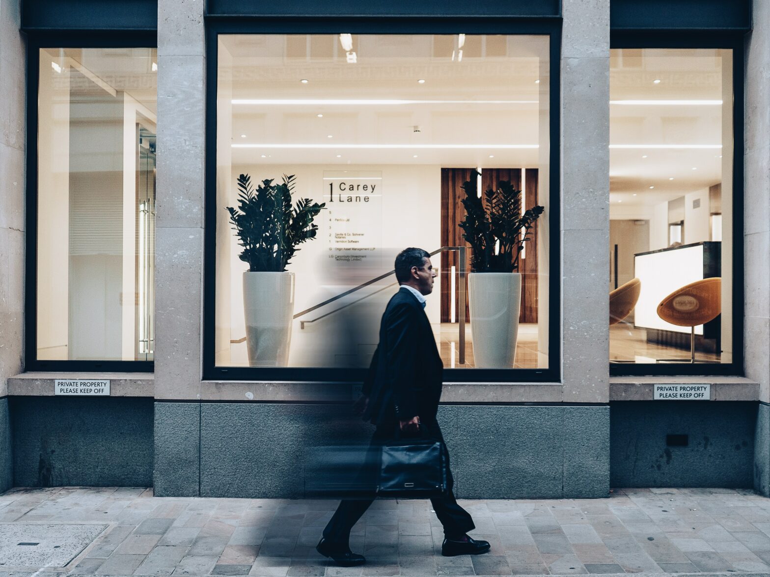 Man dressed in a suit walking through London